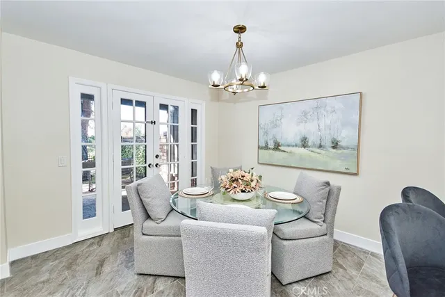 a dining room with furniture wooden floor and a chandelier
