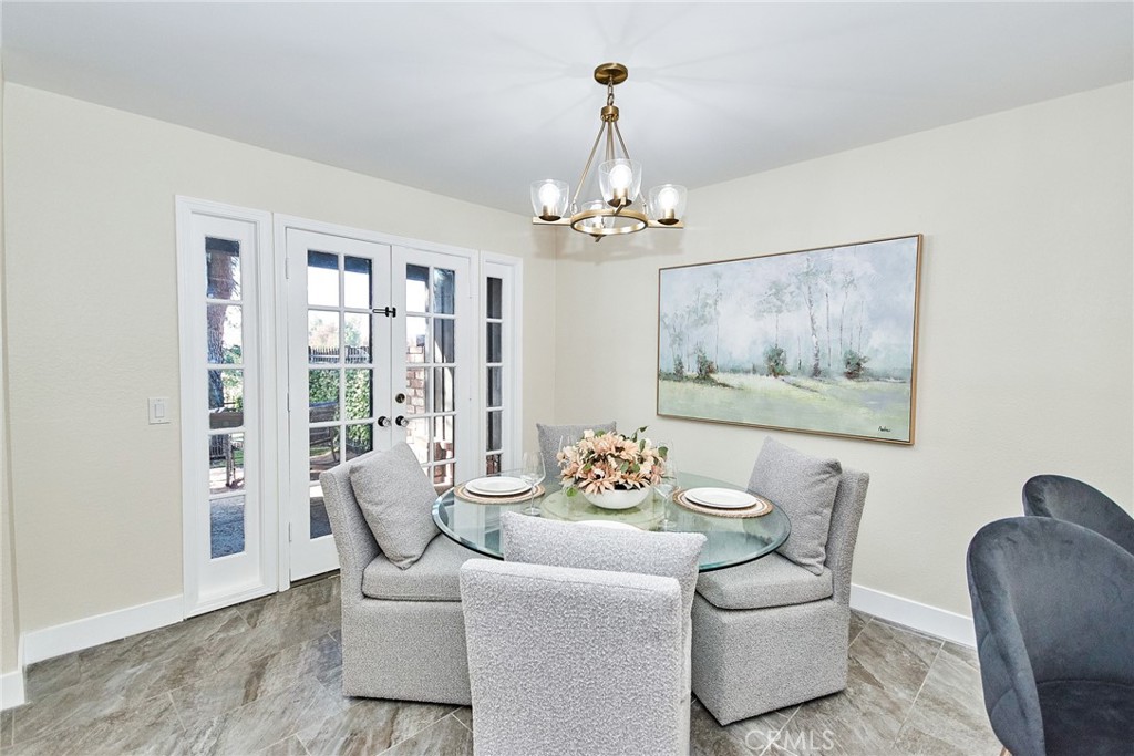 950 South Rim Crest Drive Anaheim Hills, CA 92807 - Photo 11 of 40 a dining room with furniture wooden floor and a chandelier