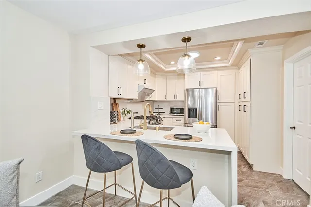 a kitchen with white cabinets and white appliances