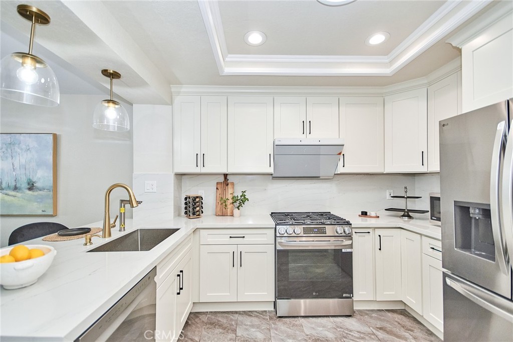 950 South Rim Crest Drive Anaheim Hills, CA 92807 - Photo 17 of 40 a kitchen with a sink stove and refrigerator
