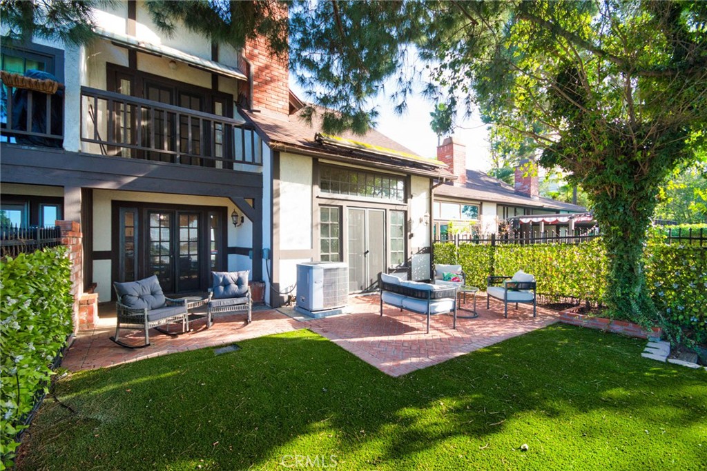950 South Rim Crest Drive Anaheim Hills, CA 92807 - Photo 2 of 40 a view of a patio with table and chairs and potted plants and large tree