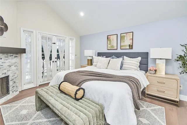 a bedroom with a bed and a fireplace