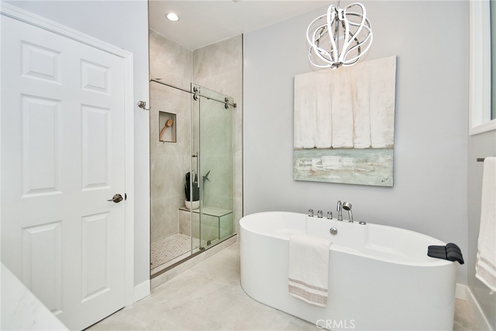 950 South Rim Crest Drive Anaheim Hills, CA 92807 - Photo 24 of 40 a bathroom with a bathtub and a shower