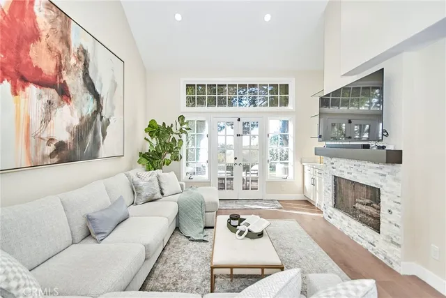 a living room with furniture a fireplace and a table