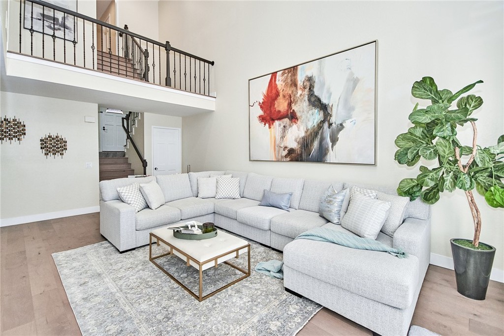 950 South Rim Crest Drive Anaheim Hills, CA 92807 - Photo 10 of 40 a living room with furniture a couch and a potted plant