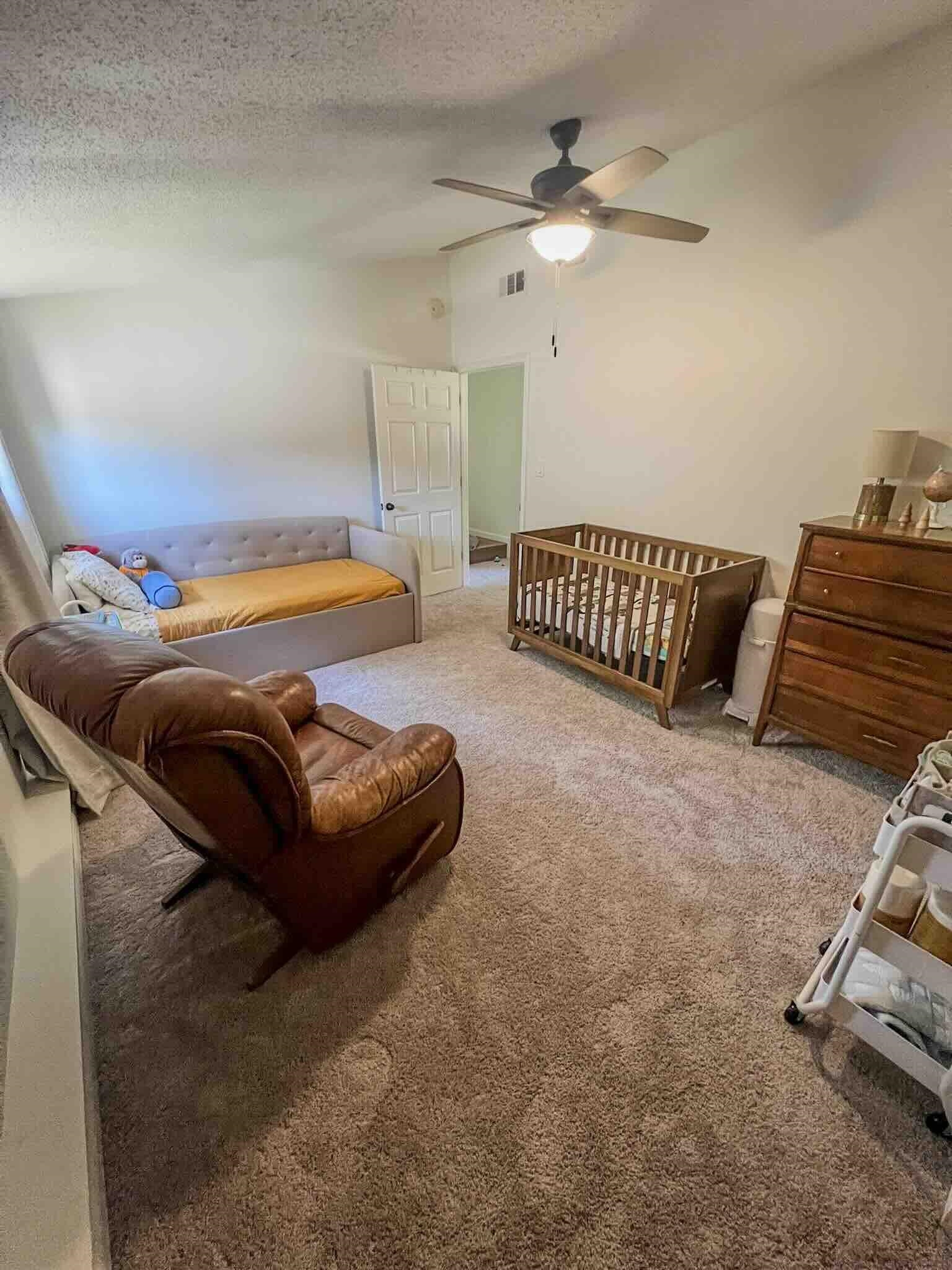 2578 Elmore Park Road Bartlett, TN 38134 - Photo 18 of 24 a bedroom with a bed and a chandelier