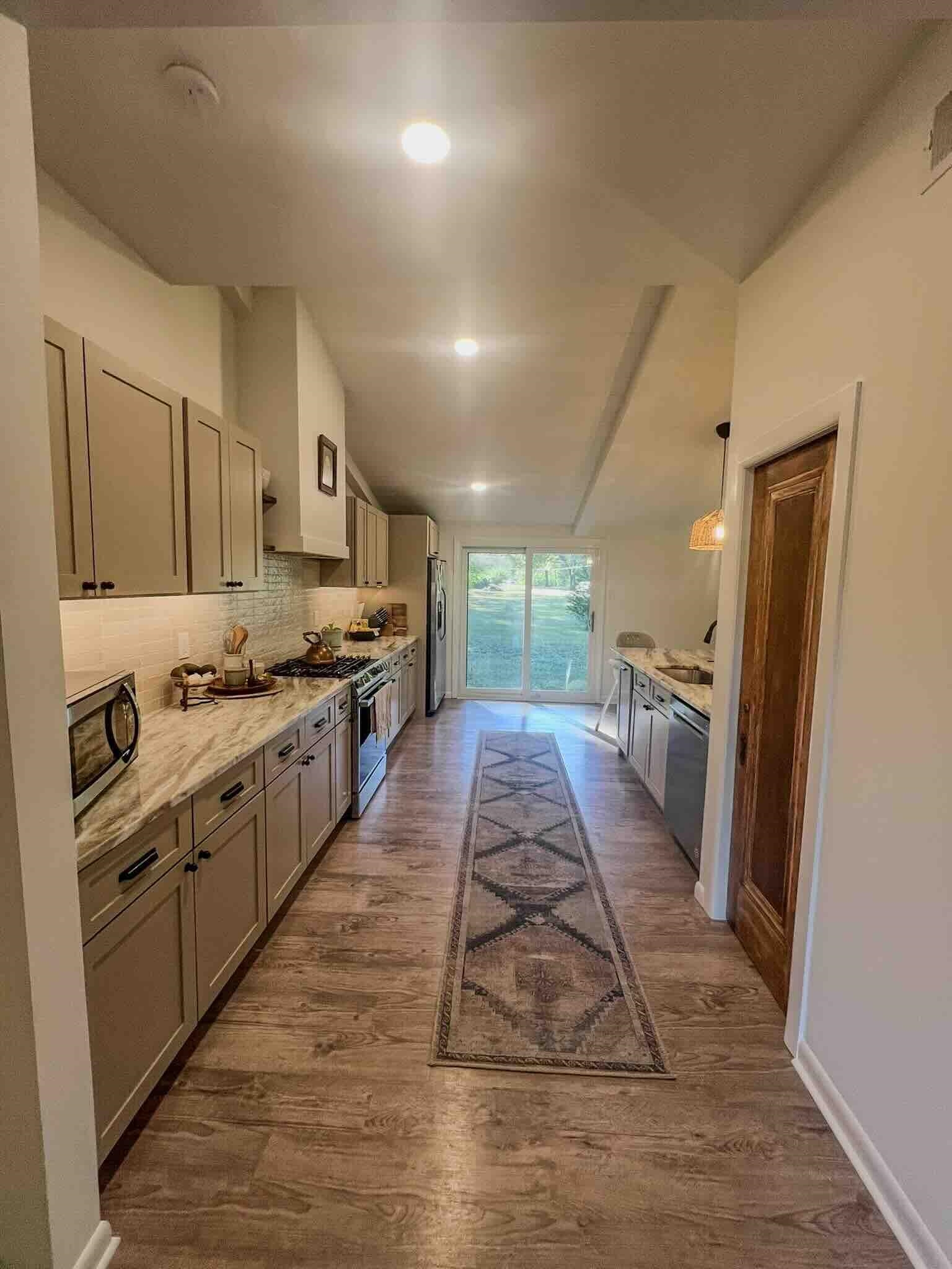 2578 Elmore Park Road Bartlett, TN 38134 - Photo 2 of 24 a large kitchen with stainless steel appliances kitchen island granite countertop a large stove top oven a sink dishwasher and a refrigerator