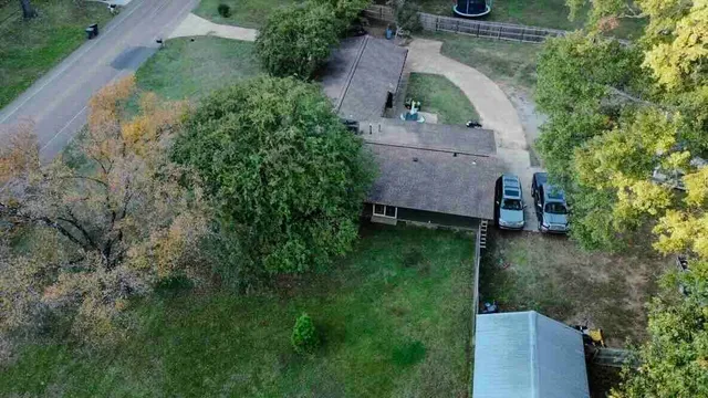 an aerial view of a house with a yard