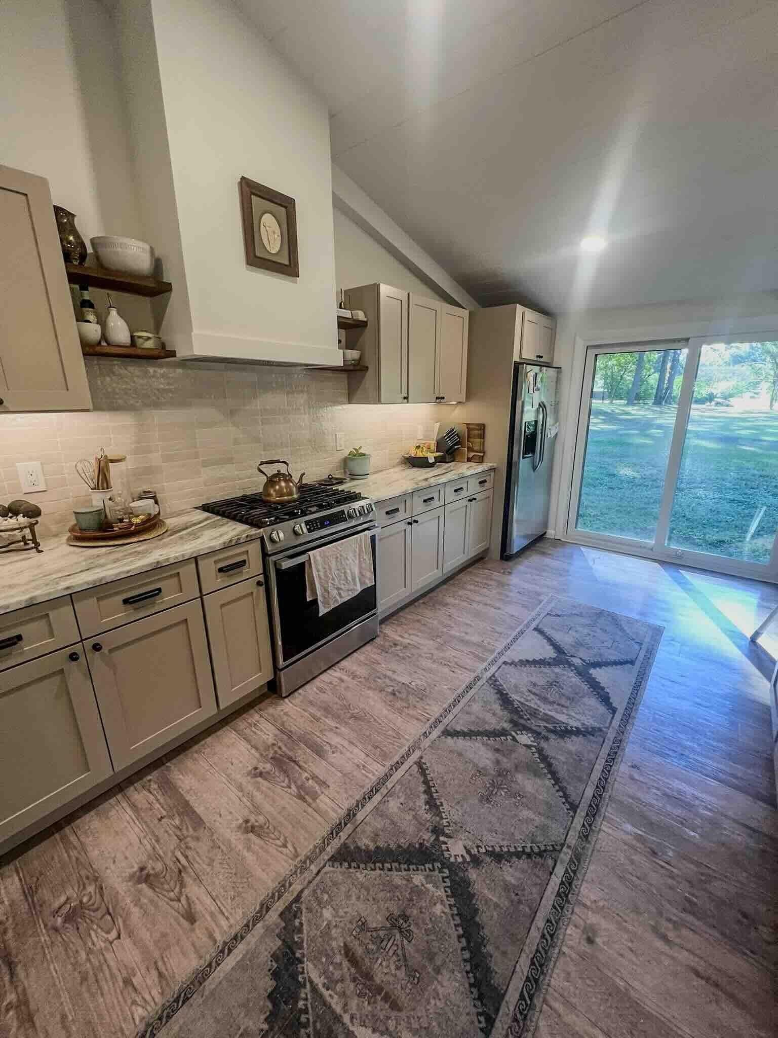 2578 Elmore Park Road Bartlett, TN 38134 - Photo 3 of 24 a kitchen with stainless steel appliances granite countertop a stove sink and cabinets