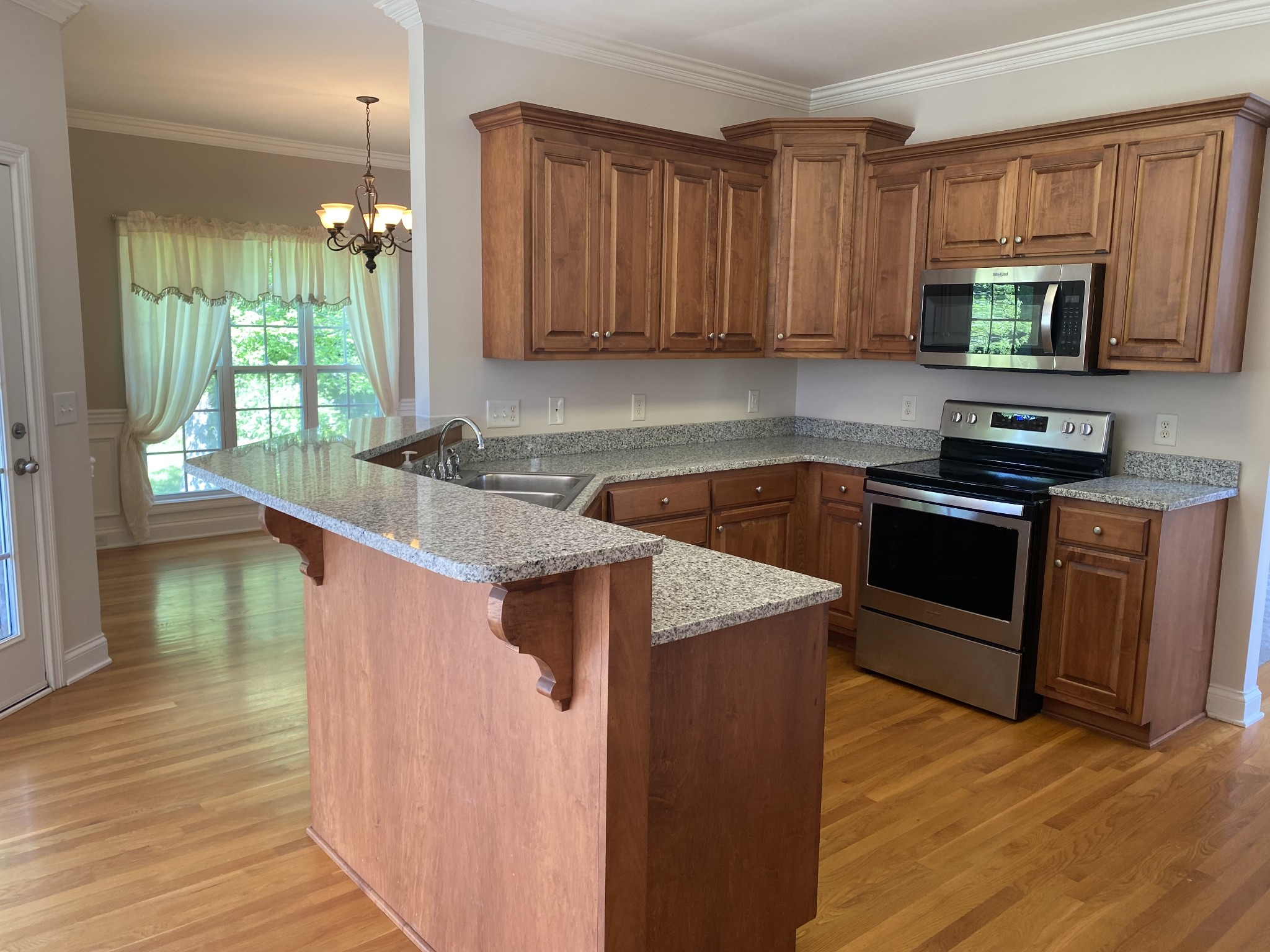 720 Heritage Road Lebanon, TN 37087 - Photo 11 of 31 a kitchen with stainless steel appliances granite countertop a stove a sink and a microwave