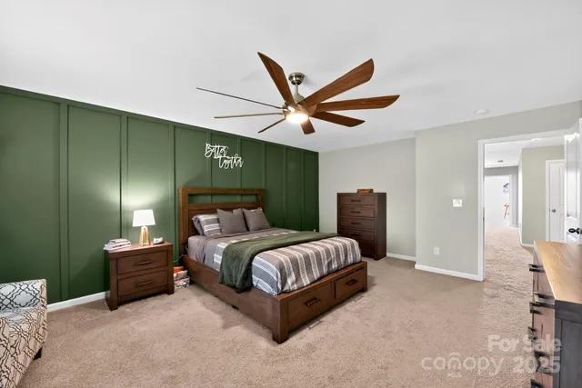 a spacious bedroom with a bed and a ceiling fan