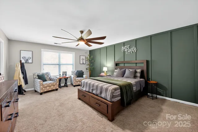 a spacious bedroom with a bed and window