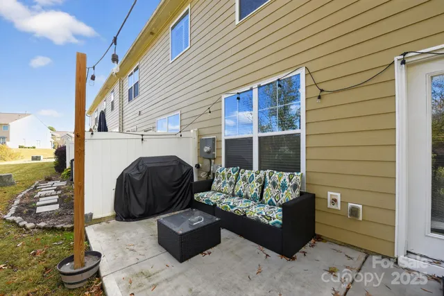 a building outdoor space with patio furniture and a fireplace