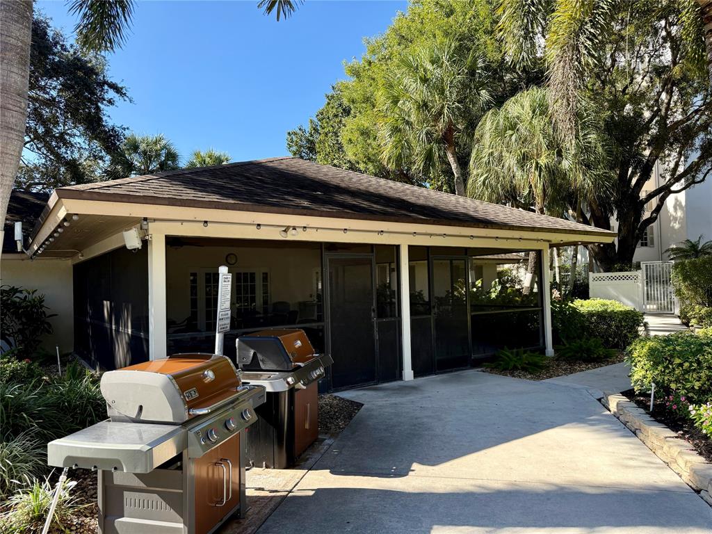 3520 Oaks Way, Unit 306 Pompano Beach, FL 33069 - Photo 13 of 18 a view of a house with backyard sitting area and porch