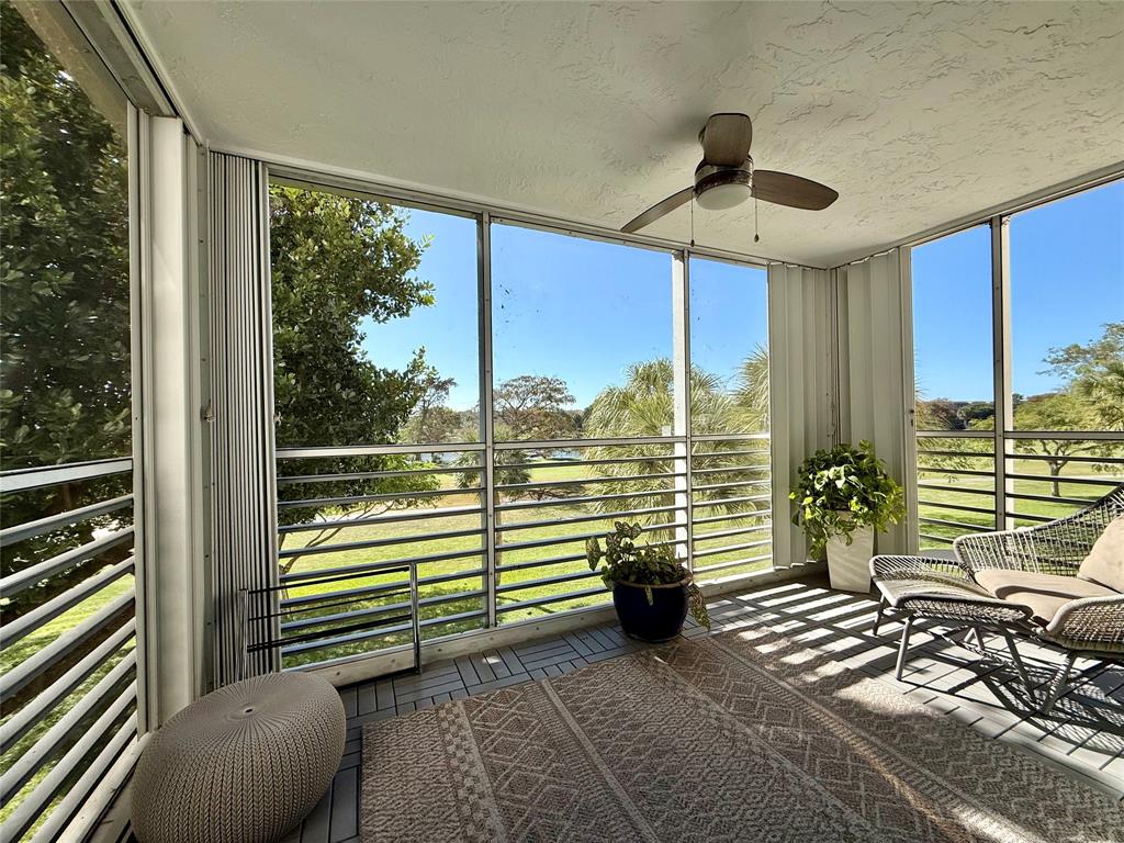 3520 Oaks Way, Unit 306 Pompano Beach, FL 33069 - Photo 4 of 18 a view of a chairs and table in the balcony
