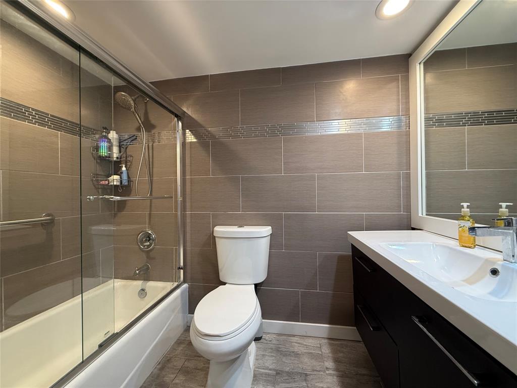 3520 Oaks Way, Unit 306 Pompano Beach, FL 33069 - Photo 9 of 18 a bathroom with a sink toilet and shower