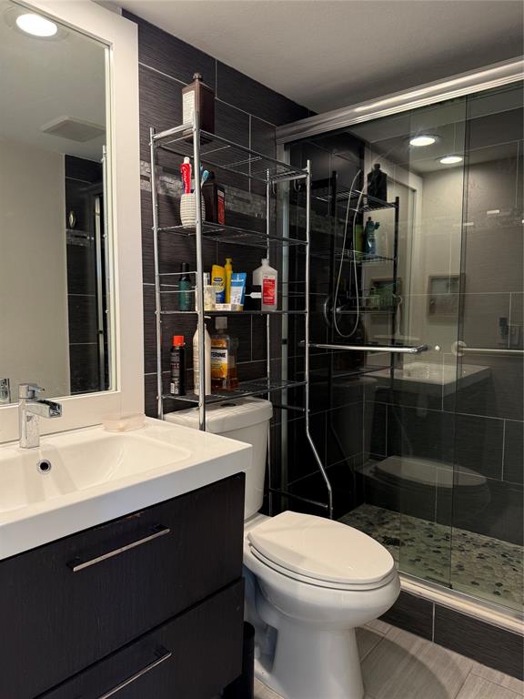 3520 Oaks Way, Unit 306 Pompano Beach, FL 33069 - Photo 10 of 18 a bathroom with a sink a toilet and shower