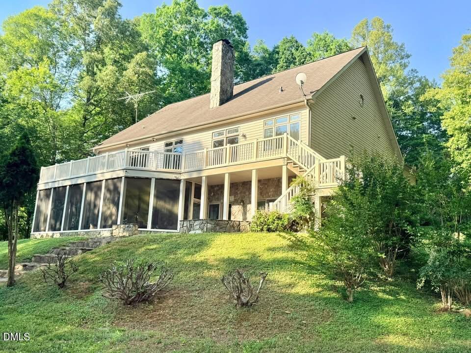 a view of a house with yard and sitting area