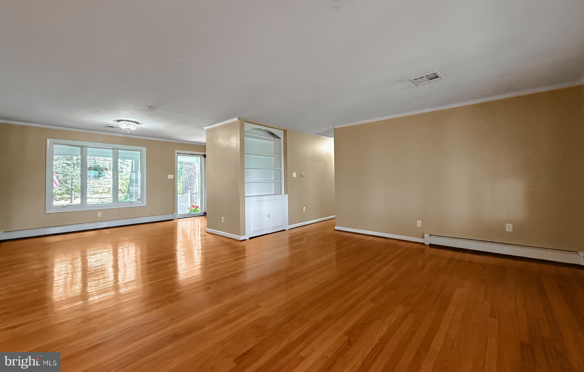 19479 North Snow Hill Manor Road Lexington Park, MD 20653 - Photo 11 of 34 an empty room with wooden floor and windows