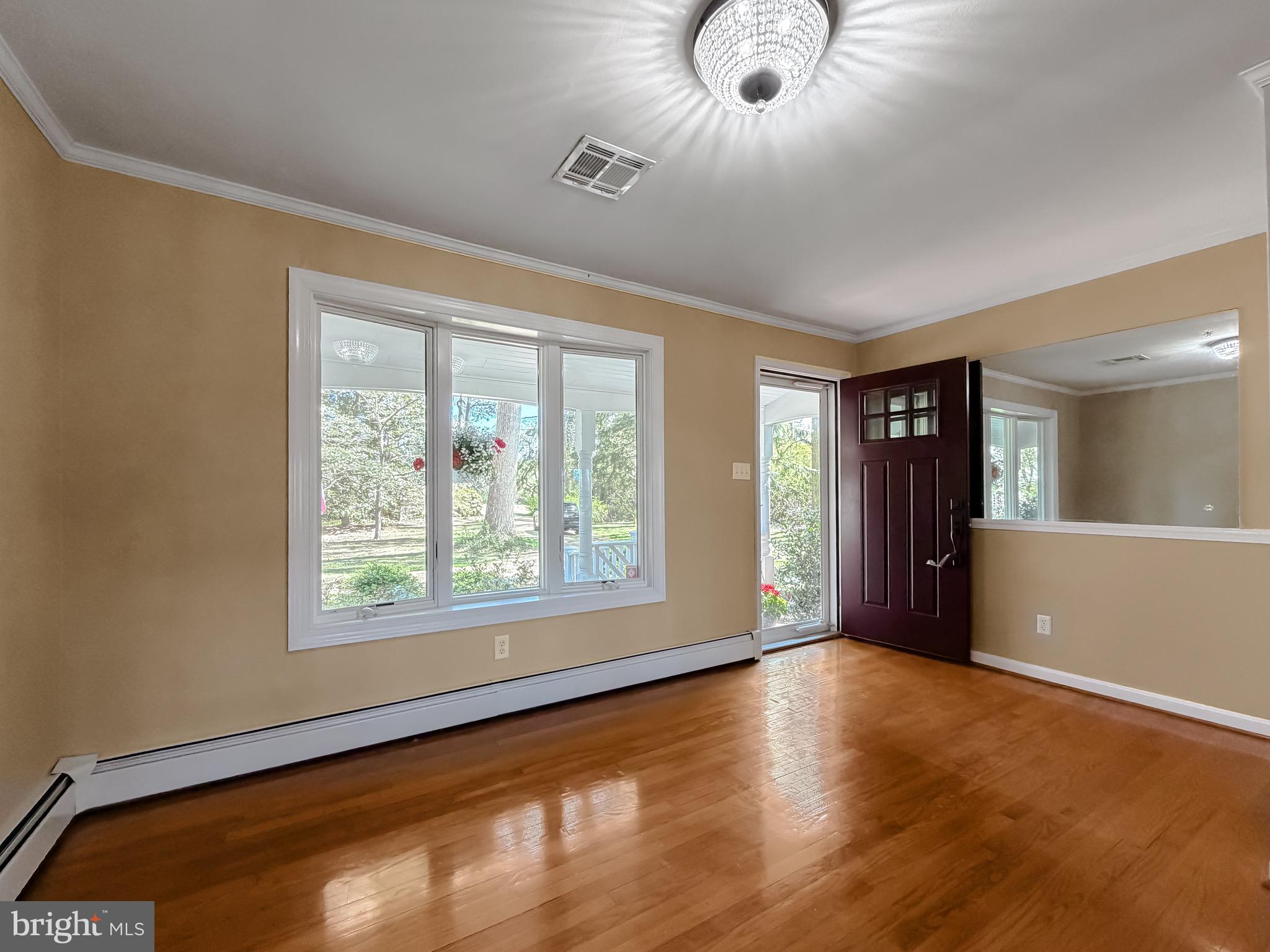 19479 North Snow Hill Manor Road Lexington Park, MD 20653 - Photo 12 of 34 a view of an empty room with wooden floor and a window