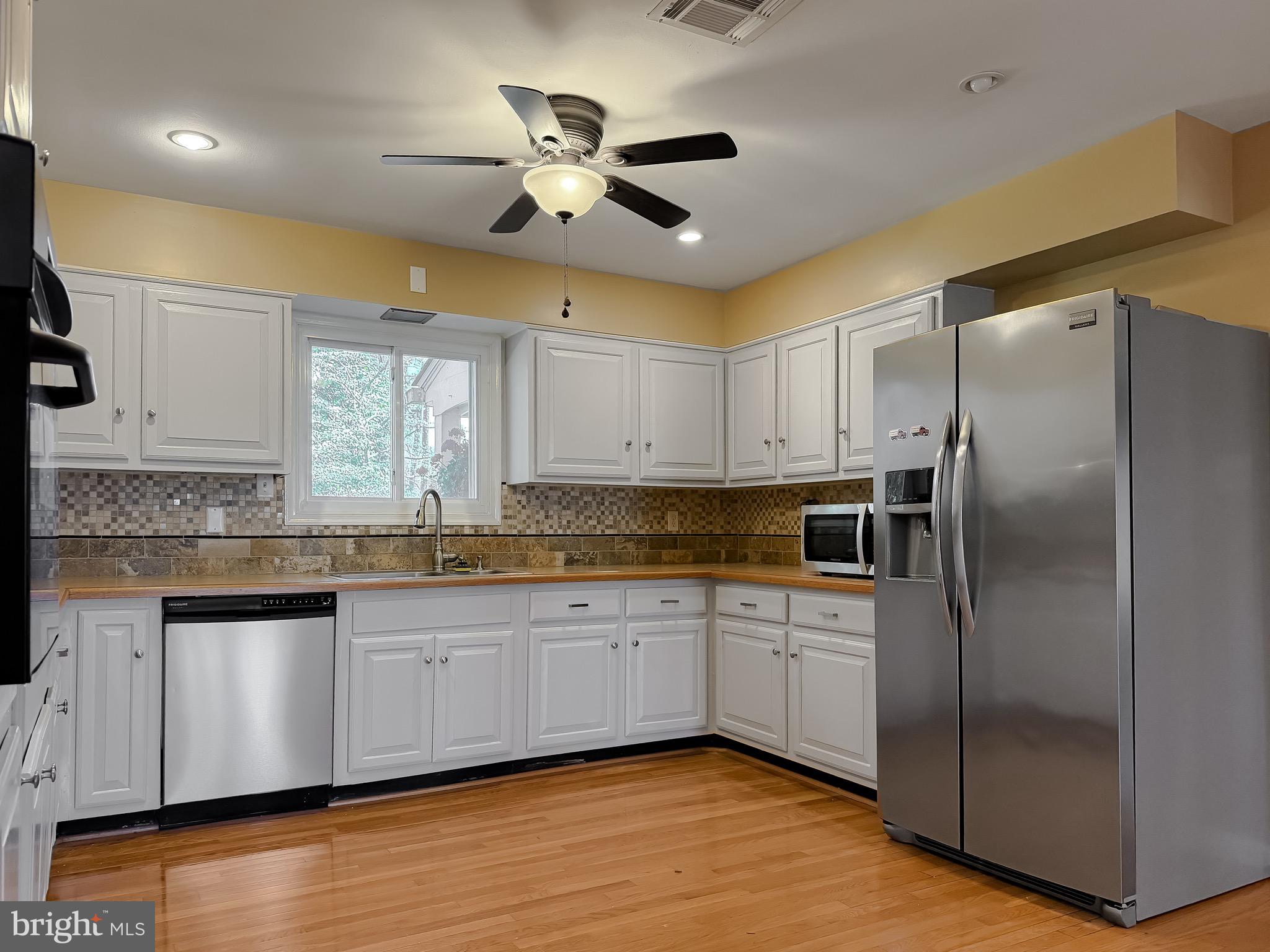 19479 North Snow Hill Manor Road Lexington Park, MD 20653 - Photo 15 of 34 a kitchen with stainless steel appliances granite countertop a sink a refrigerator and a stove