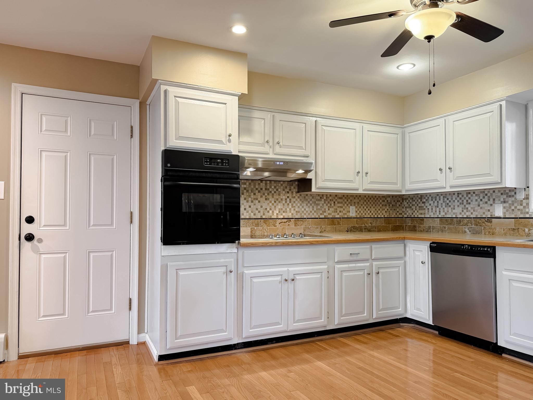 19479 North Snow Hill Manor Road Lexington Park, MD 20653 - Photo 16 of 34 a kitchen with stainless steel appliances granite countertop a stove a sink and white cabinets