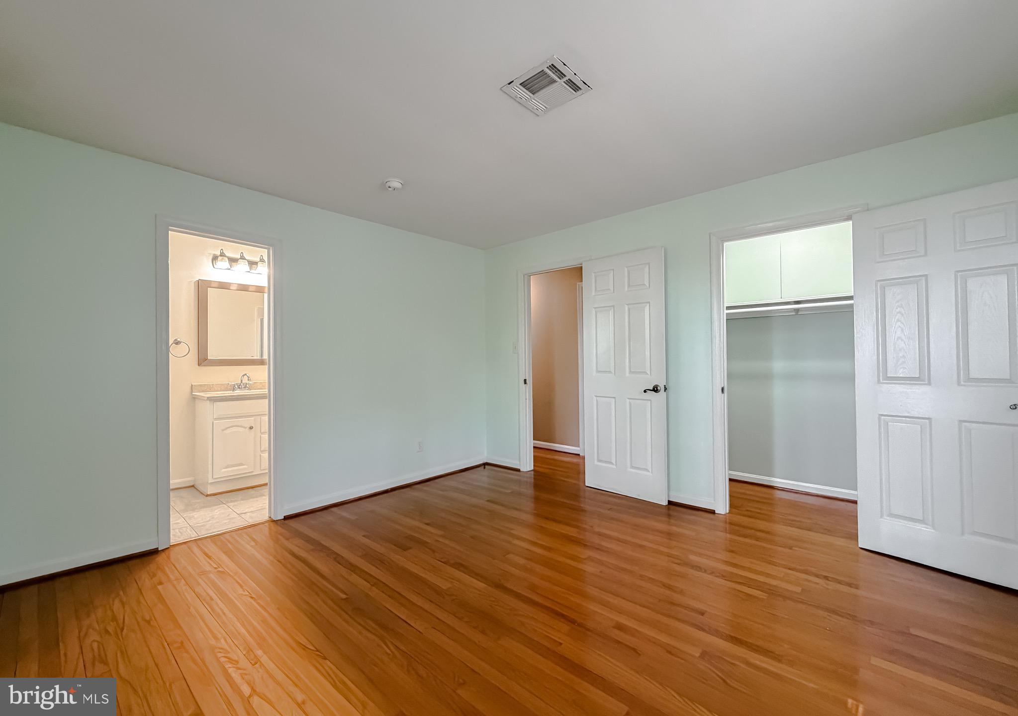 19479 North Snow Hill Manor Road Lexington Park, MD 20653 - Photo 23 of 34 a view of an empty room with wooden floor and closet