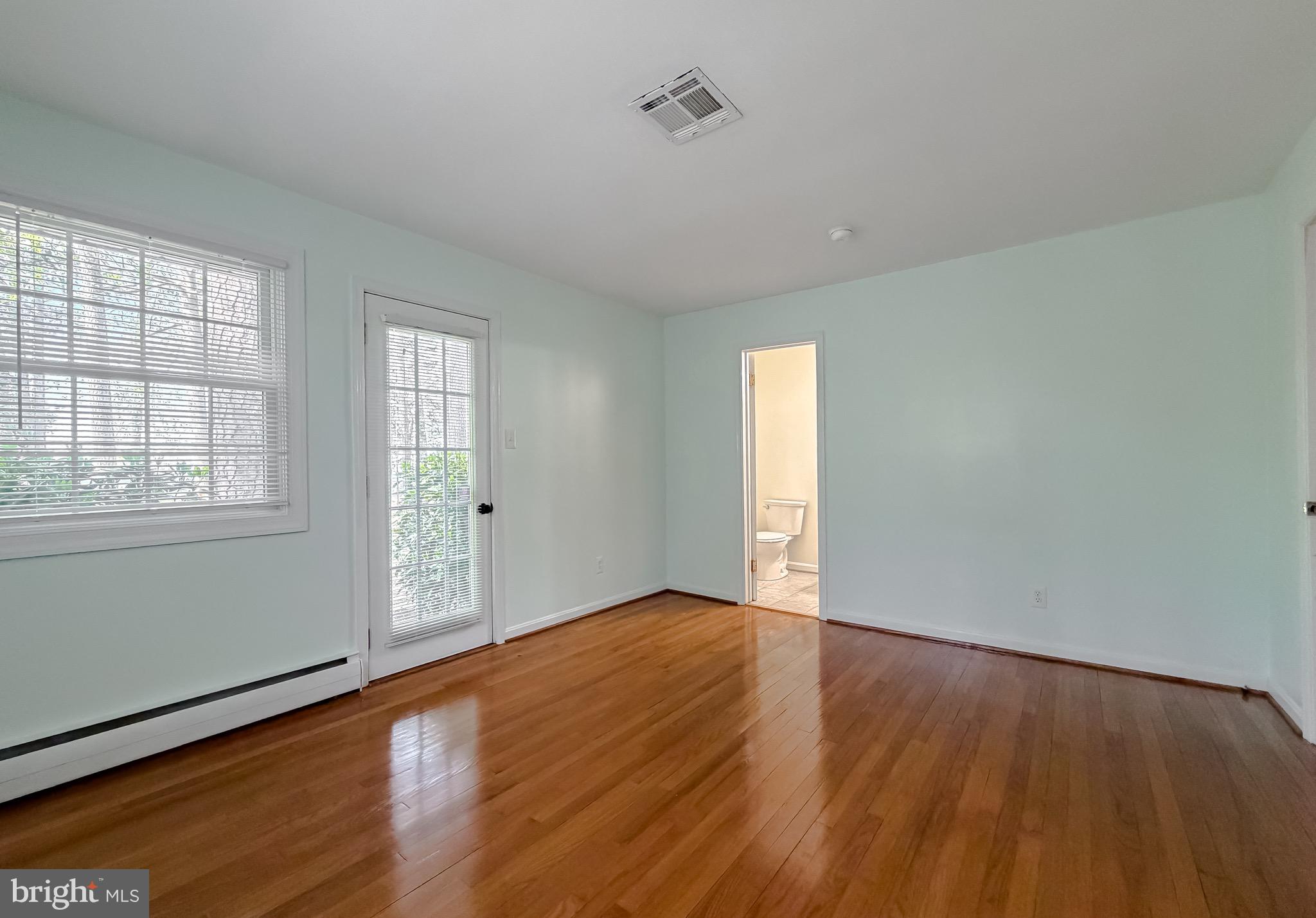 19479 North Snow Hill Manor Road Lexington Park, MD 20653 - Photo 24 of 34 an empty room with wooden floor and windows