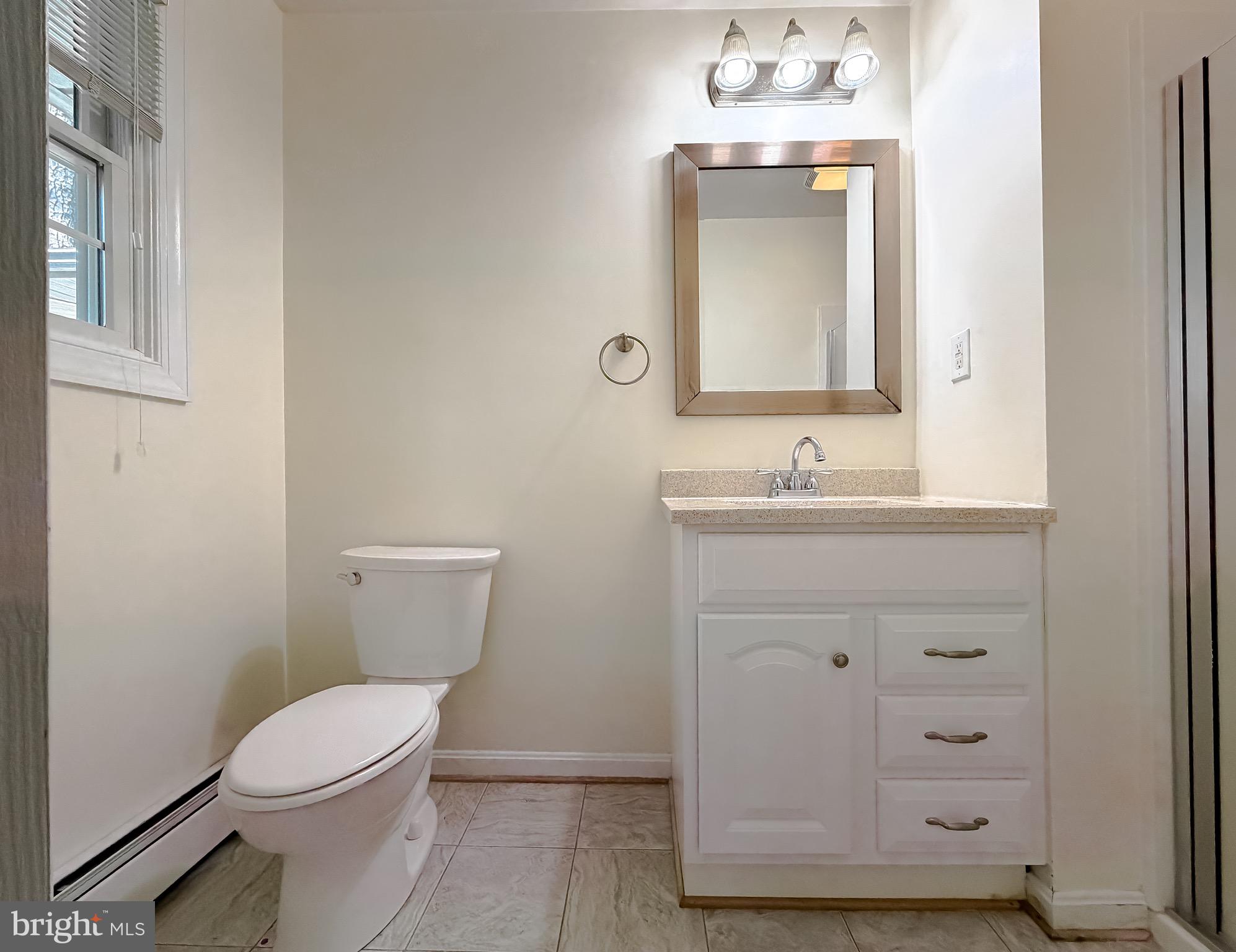 19479 North Snow Hill Manor Road Lexington Park, MD 20653 - Photo 25 of 34 a bathroom with a granite countertop toilet sink and mirror