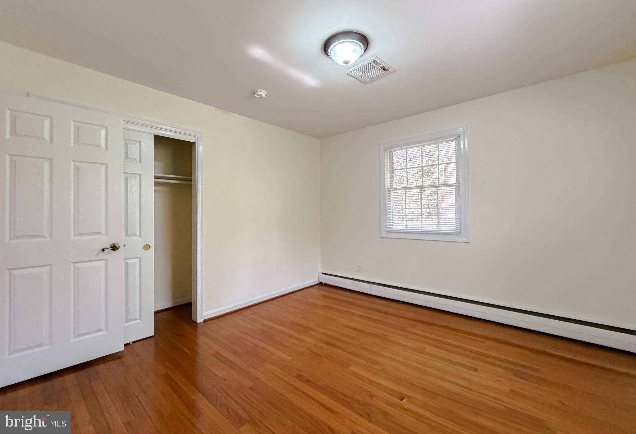 19479 North Snow Hill Manor Road Lexington Park, MD 20653 - Photo 26 of 34 an empty room with wooden floor closet and windows