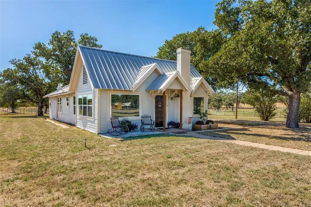 a view of a house with a yard patio and fire pit