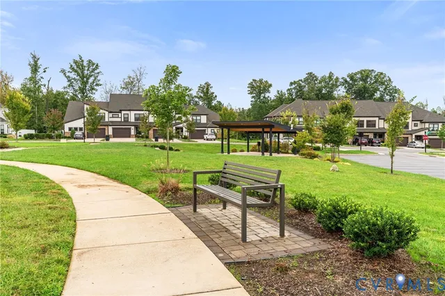 a view of a park with bench and trees