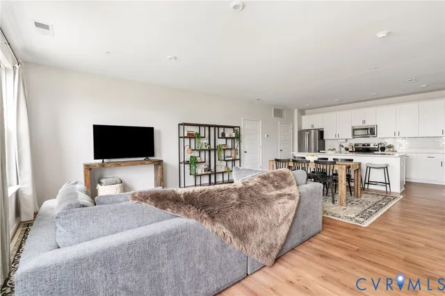 a bedroom with a bed a flat screen tv and a couch