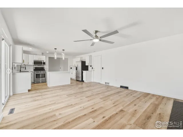 a view of a kitchen with a sink and a refrigerator