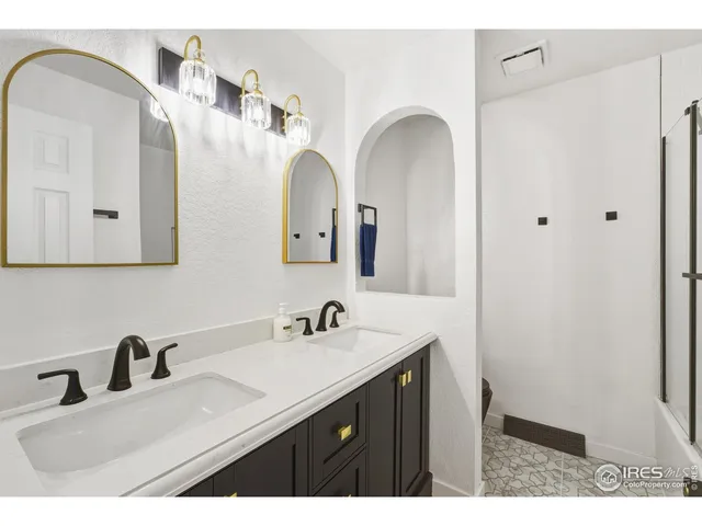a bathroom with a double vanity sink and a mirror