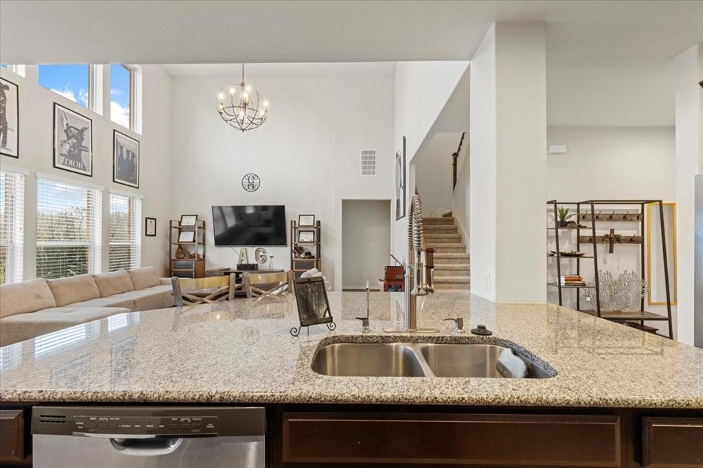 11306 Runnel Ridge Road Manor, TX 78653 - Photo 12 of 26 a view of a kitchen counter top a sink and living room view