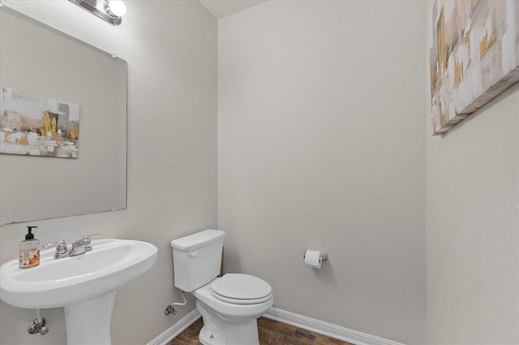11306 Runnel Ridge Road Manor, TX 78653 - Photo 13 of 26 a bathroom with a sink mirror and toilet