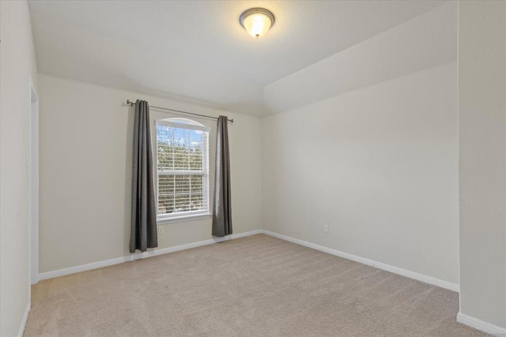 11306 Runnel Ridge Road Manor, TX 78653 - Photo 21 of 26 a view of an empty room with a window
