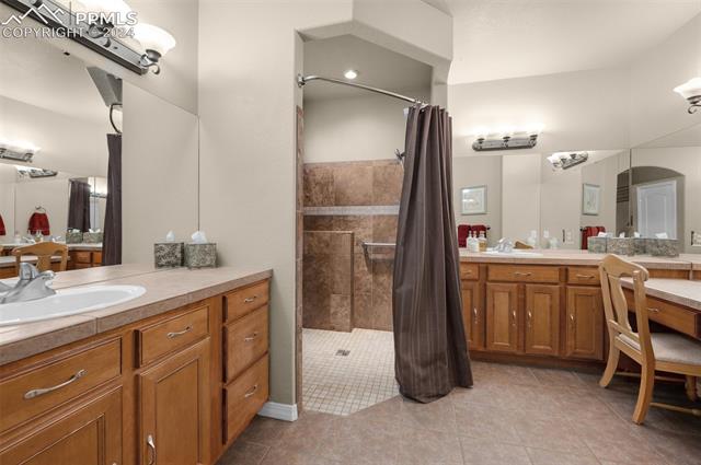 533 Talus Road Monument, CO 80132 - Photo 29 of 46 Bathroom featuring tile patterned flooring, vanity, and walk in shower