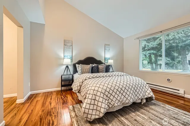 a bedroom with double bed and a window
