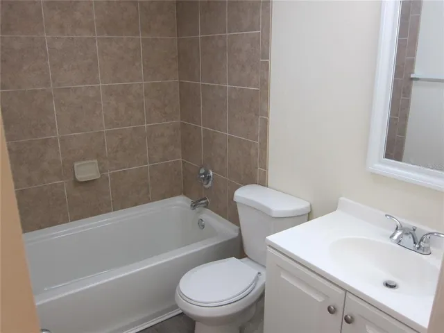 a bathroom with a toilet a sink and bathtub