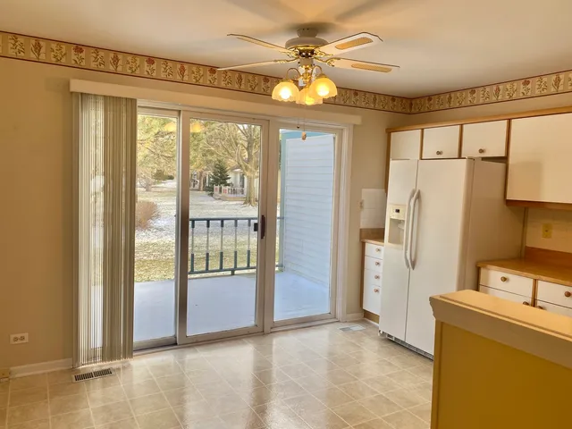 a view of a room with a large window and chandelier