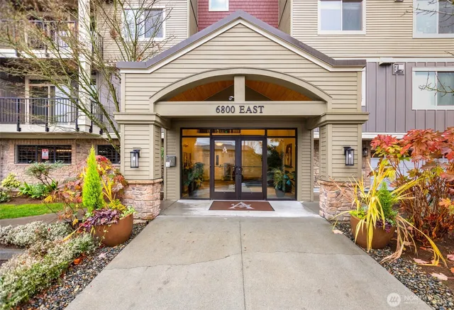 a front view of a house with outdoor seating and a potted plant