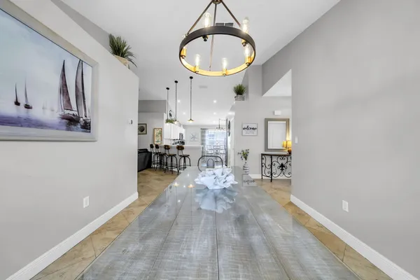 a view of a room with wooden floor a glass table and chairs