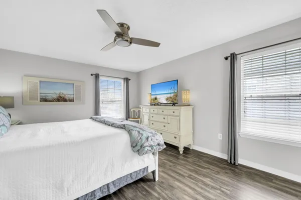 a bedroom with a large bed and a tv on the dresser