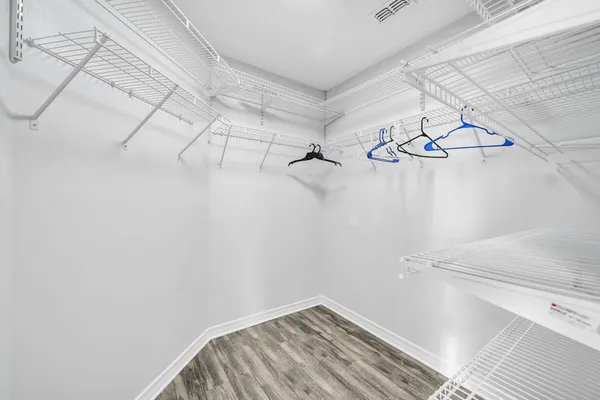 a bedroom with a large bed and a ceiling fan