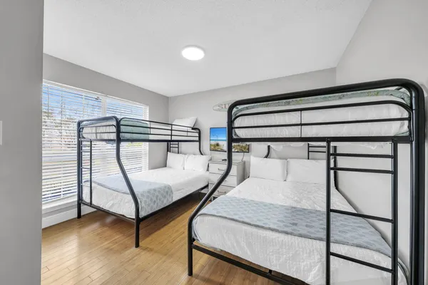 a way to room with wooden floor and stairs