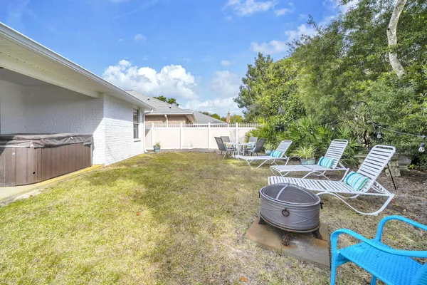 a view of a swimming pool with a lawn chairs and a fire pit