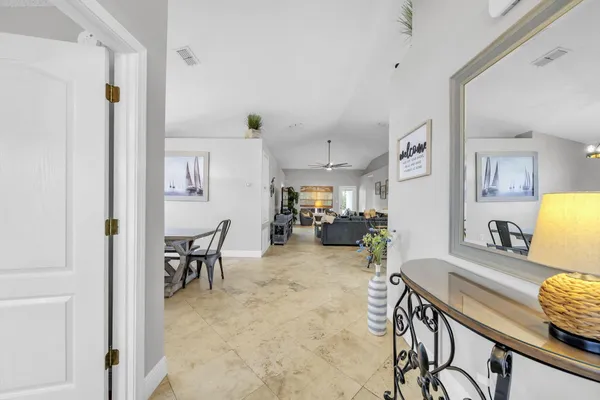 a living room with furniture and a dining table