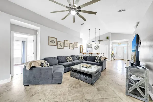 a living room with furniture and a chandelier